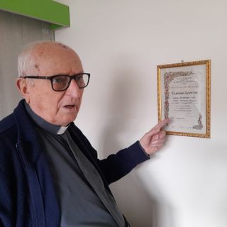 Monsignor Livetti indica l'attestato del suo Battesimo