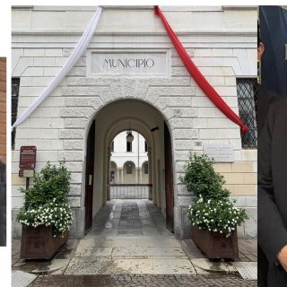 A sinistra Giavini, a destra Paglini: al centro il municipio &quot;vestito&quot; da patronale (foto da pagina Facebook Comune)