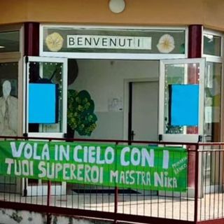 Lo striscione dedicato alla maestra Nika affisso all'ingresso della scuola di Ranco