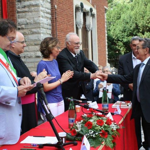 Pietro Magistrelli ritira la civica benemerenza nel 2014 (foto Città di Busto Arsizio). Sotto con l'allora assessore ai Servizi sociali Miriam Arabini