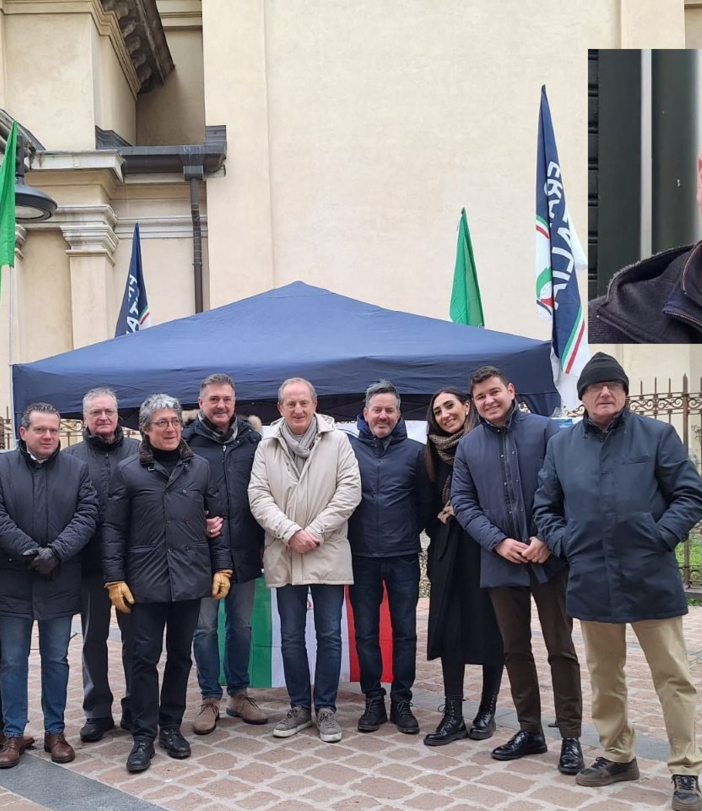Il gazebo di FdI. Nel riquadro, Alberto Falciglia
