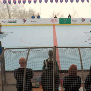 Le compagne del Milano e le Scomed Bomporto immobili in pista, dopo aver lasciato i bastoni, i guanti e i caschi davanti a loro in memoria di Emma