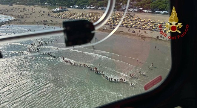 La catena umana dei bagnanti impegnati nelle ricerche del bambino a Jesolo
