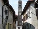 Via San Carlo, una delle strade del borgo ‘antico’, dominata dal campanile della vecchia Parrocchiale: è ben riconoscibile il suo impianto quattrocentesco (mattoni, archetti ciechi decorativi) simile a quello di San Giovanni, ed il sopralzo con la cella campanaria realizzato in epoca più recente